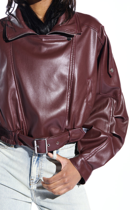 buttery soft burgundy faux leather statement jacket with a zip up front closure, puffy sleeves, and a belted accent on the bottom