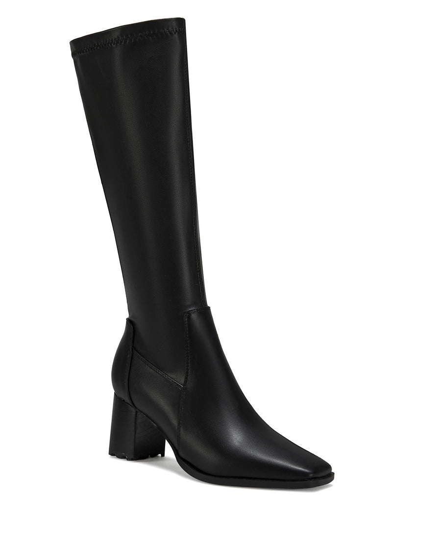 black faux leather knee high boots with a 4 way stretch shaft, a block heel, and a pointed toe silhouette