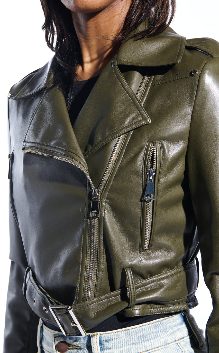 olive green faux leather statement moto jacket with zip up accents, an adjustable belt on the bottom, and a classic moto collar