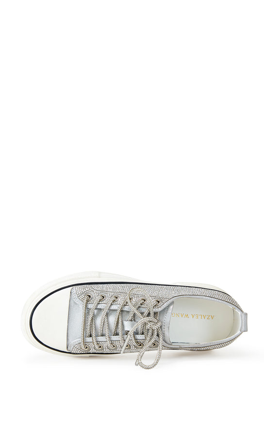 silver lace up sneaker with a white sole and sparkly glitter embellishments on the upper