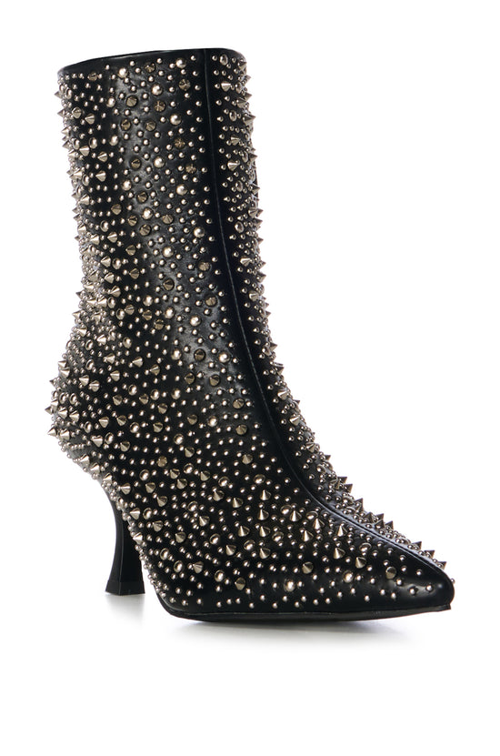 black faux leather statement booties with a subtle stiletto heel and a pointed toe silhouette, embellished with silver pointed studs on the upper