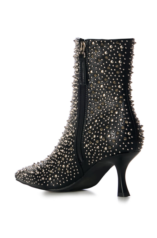 black faux leather statement booties with a subtle stiletto heel and a pointed toe silhouette, embellished with silver pointed studs on the upper