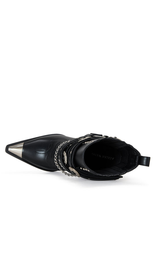 black faux leather statement western heeled bootie with silver buckle and chain accents