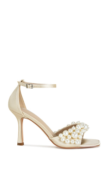 Cream satin open toe stiletto heels with an adjustable ankle strap and a faux pearl embellished foot strap