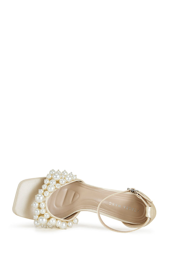 Cream satin open toe stiletto heels with an adjustable ankle strap and a faux pearl embellished foot strap