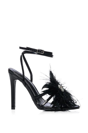 black strappy open toe heels with adjustable ankle strap and feather flower detail on front