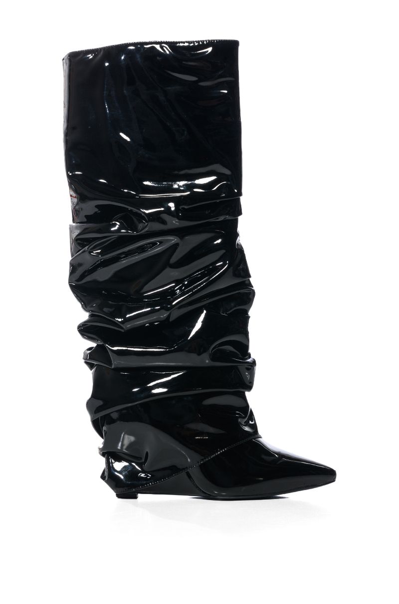 side view of shiny black patent faux leather wedge boots with a ruched detail and fold over silhouette