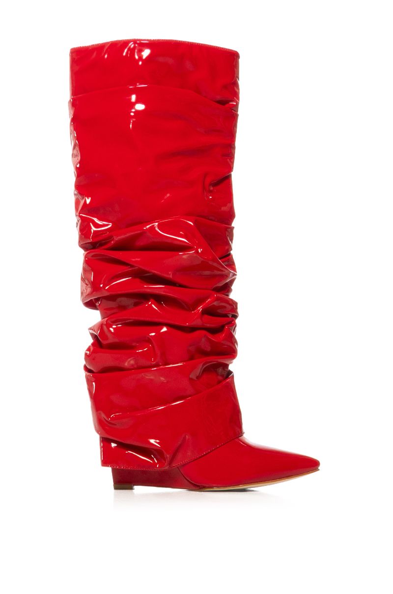side view of shiny red patent faux leather wedge boots with a ruched detail and fold over silhouette