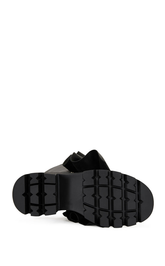 black faux leather chunky mid calf length boots with a faux leather snap button overlay that can be manipulated into different shapes
