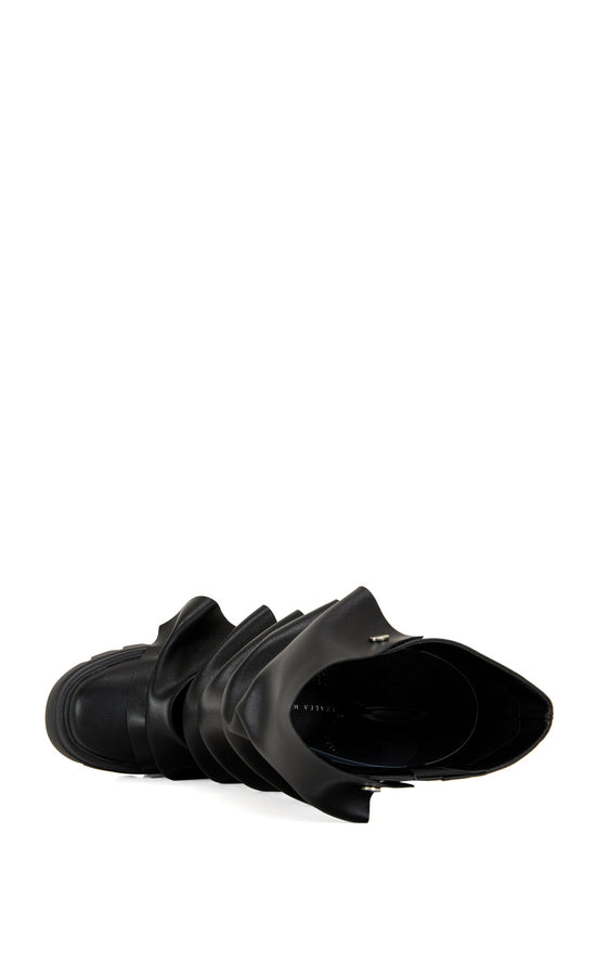 black faux leather chunky mid calf length boots with a faux leather snap button overlay that can be manipulated into different shapes