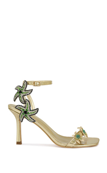gold faux leather statement open toe sandals with a stiletto heel and multicolored rhinestone embellished star accents on the side of the adjustable ankle strap and the foot strap