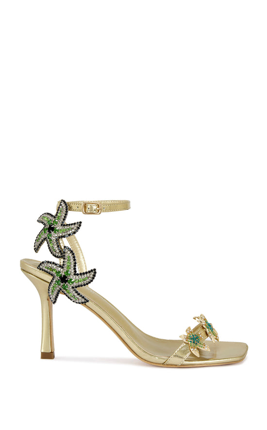 gold faux leather statement open toe sandals with a stiletto heel and multicolored rhinestone embellished star accents on the side of the adjustable ankle strap and the foot strap