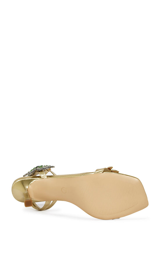 gold faux leather statement open toe sandals with a stiletto heel and multicolored rhinestone embellished star accents on the side of the adjustable ankle strap and the foot strap