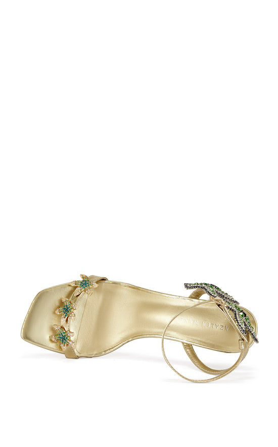 gold faux leather statement open toe sandals with a stiletto heel and multicolored rhinestone embellished star accents on the side of the adjustable ankle strap and the foot strap