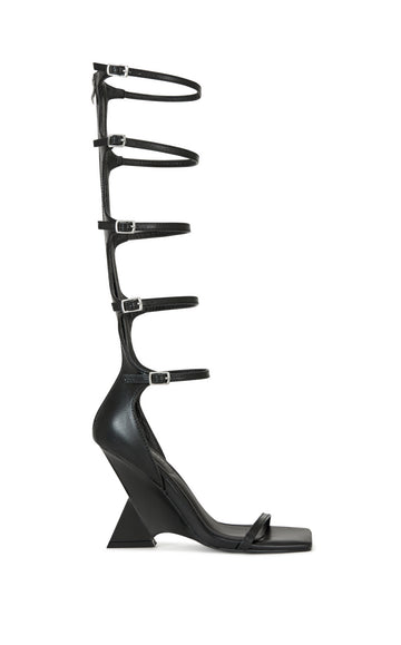 black faux leather structured wedge heel with an open toe and knee high length belted straps on the shaft