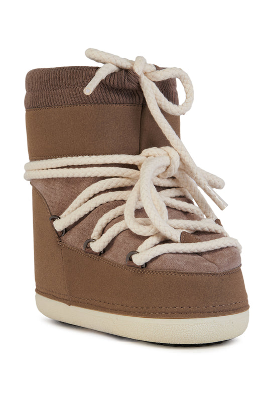 side view of light brown chunky cozy booties with a chunky white lace accent