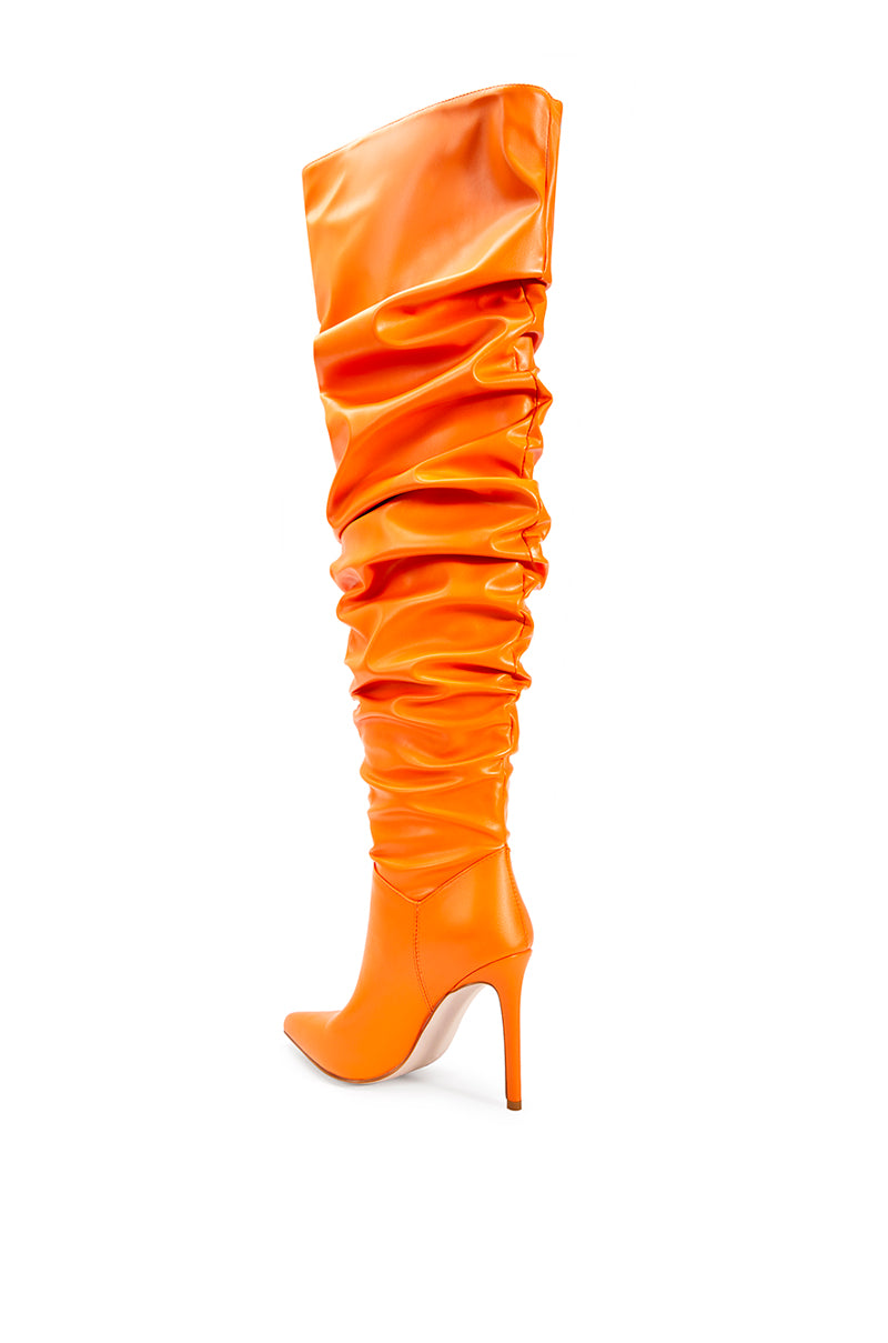 back view of orange faux leather over the knee stiletto boots with a pointed toe and ruched detail