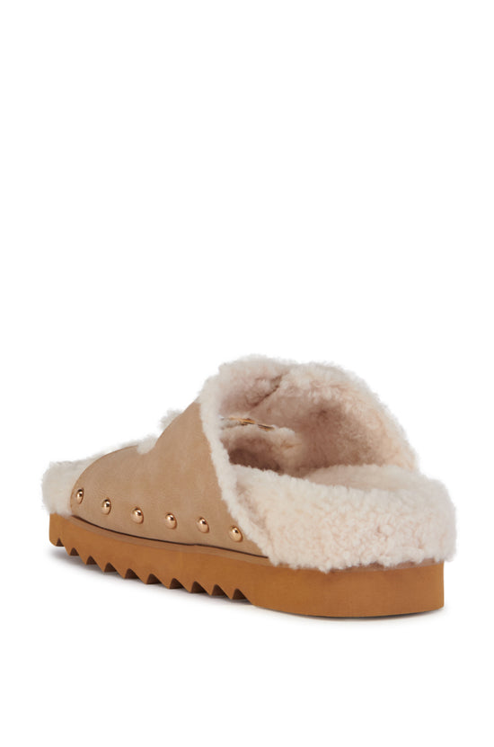 beige slip on sherpa lined cozy sandals with gold hardware accents and a ridged sole