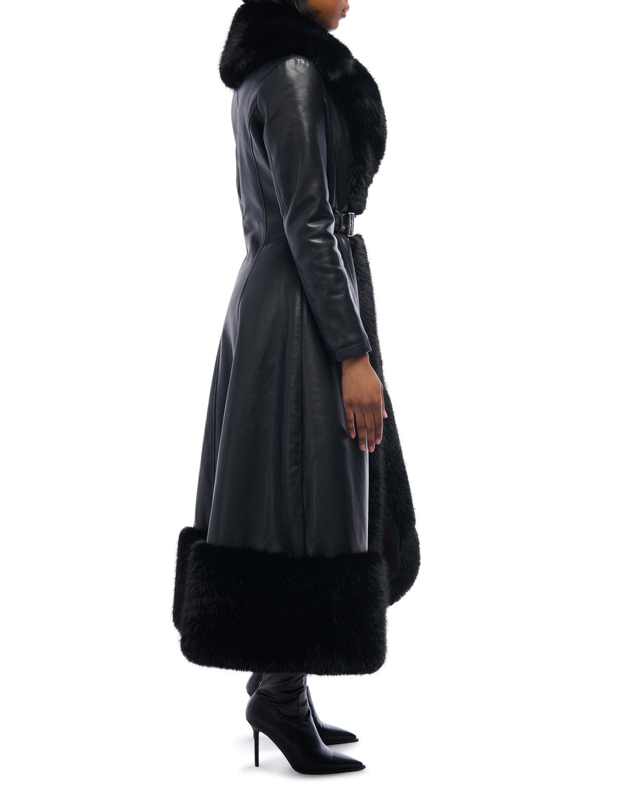 Black faux leather trench coat with a belted waist closure and black faux fur lined trim and collar