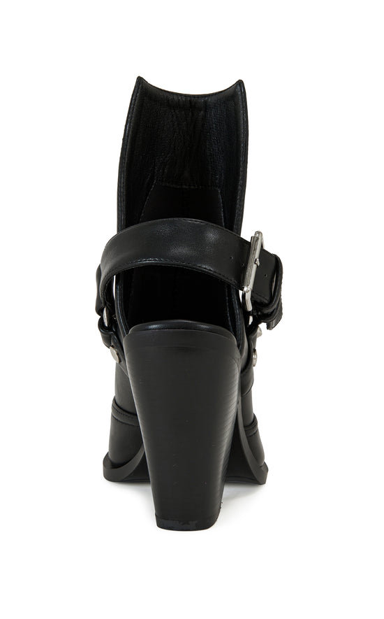 black faux leather statement western boots with a metal toe, black block heel, and and ankle cutout secured with a belted ankle strap closure