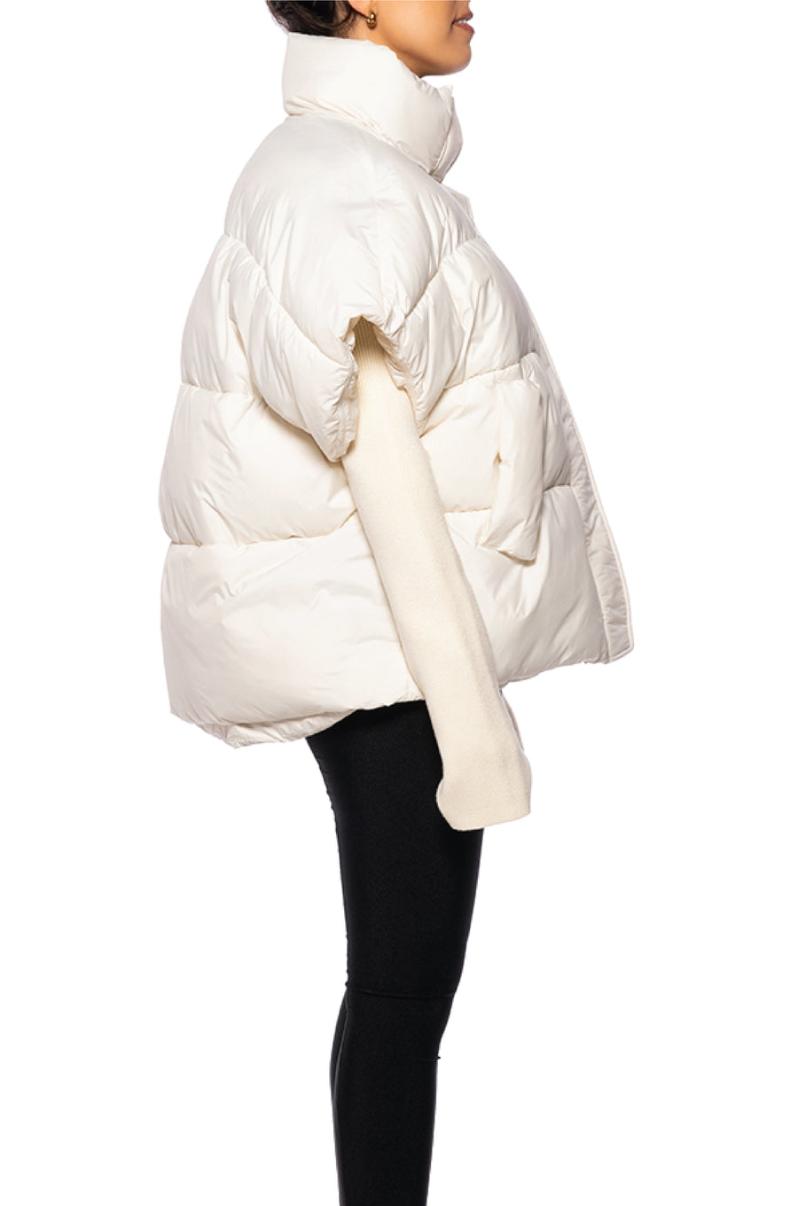 side view of unique white puffer jacket with a turtle neck white knit sleeves