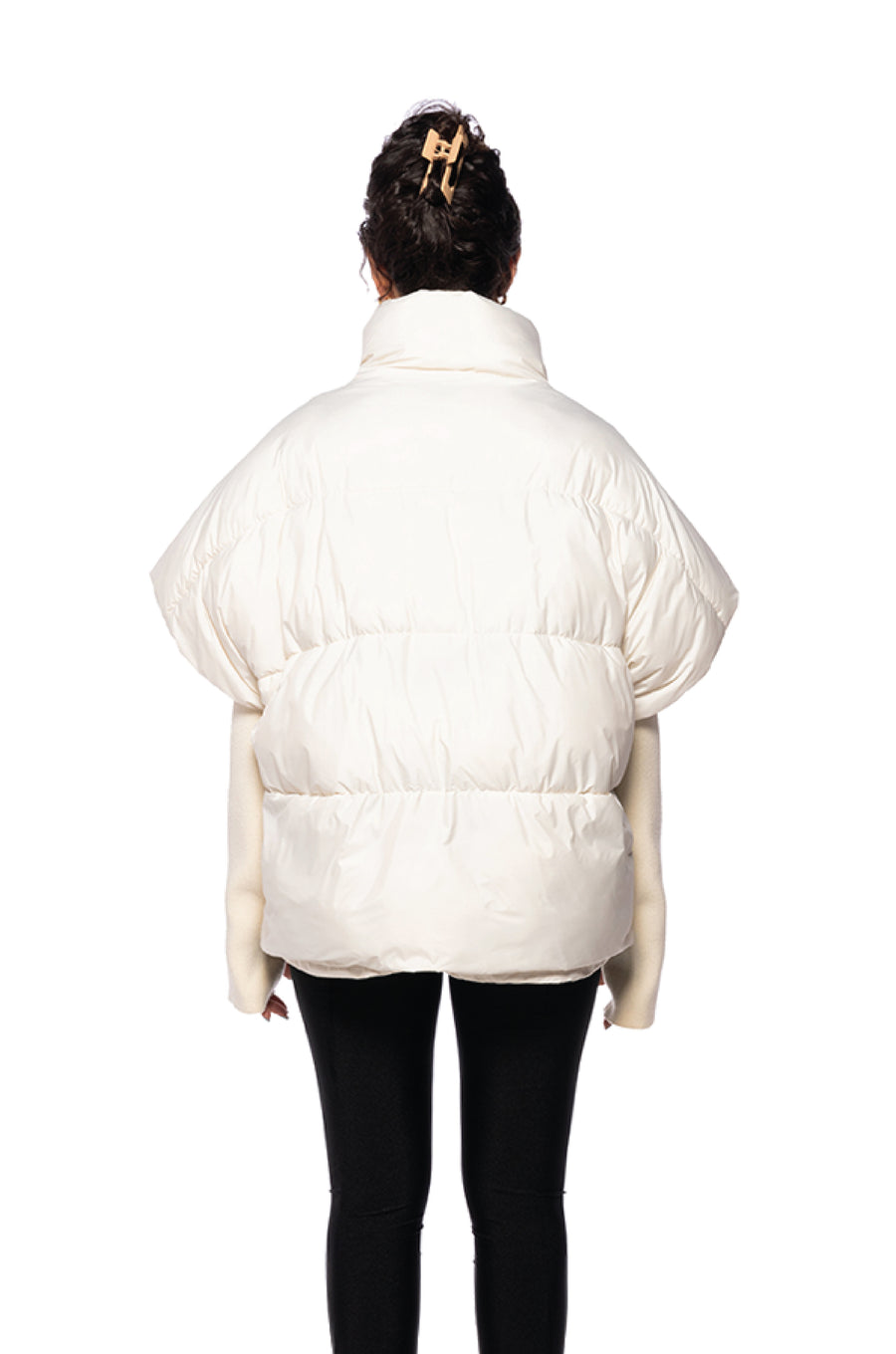 back view of unique white puffer jacket with a turtle neck white knit sleeves