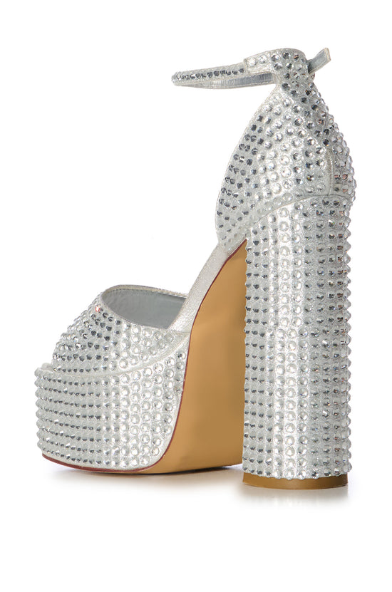 metallic silver platform crystal embellished platform statement heels with an adjustable ankle strap and a peep toe silhouette 