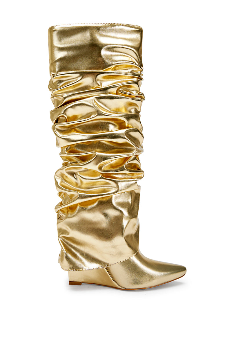 side view of metallic gold faux leather wedge boots with a pointed toe and ruched fold over silhouette