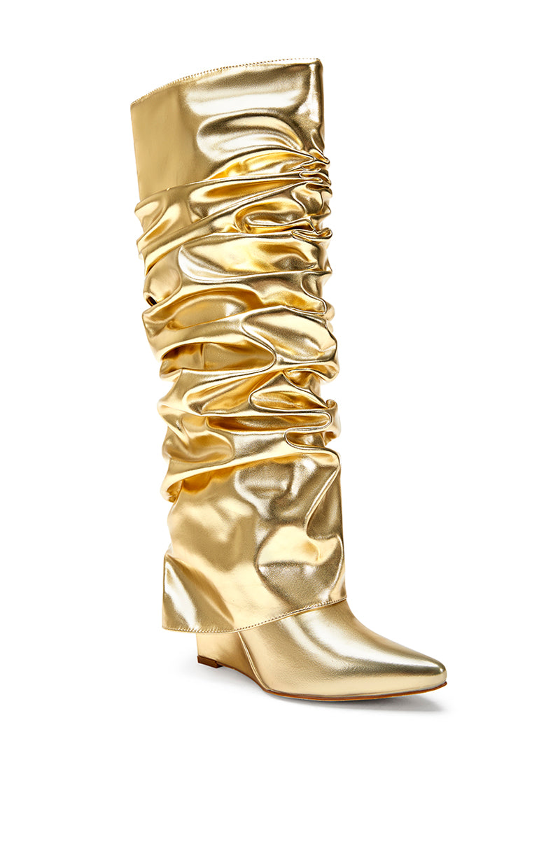 angled view of metallic gold faux leather wedge boots with a pointed toe and ruched fold over silhouette