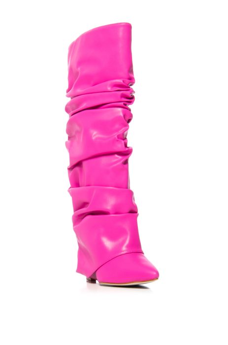 angled view of fuchsia faux leather wedge boots with a pointed toe and ruched fold over silhouette