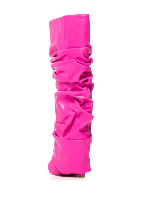 back view of fuchsia faux leather wedge boots with a pointed toe and ruched fold over silhouette