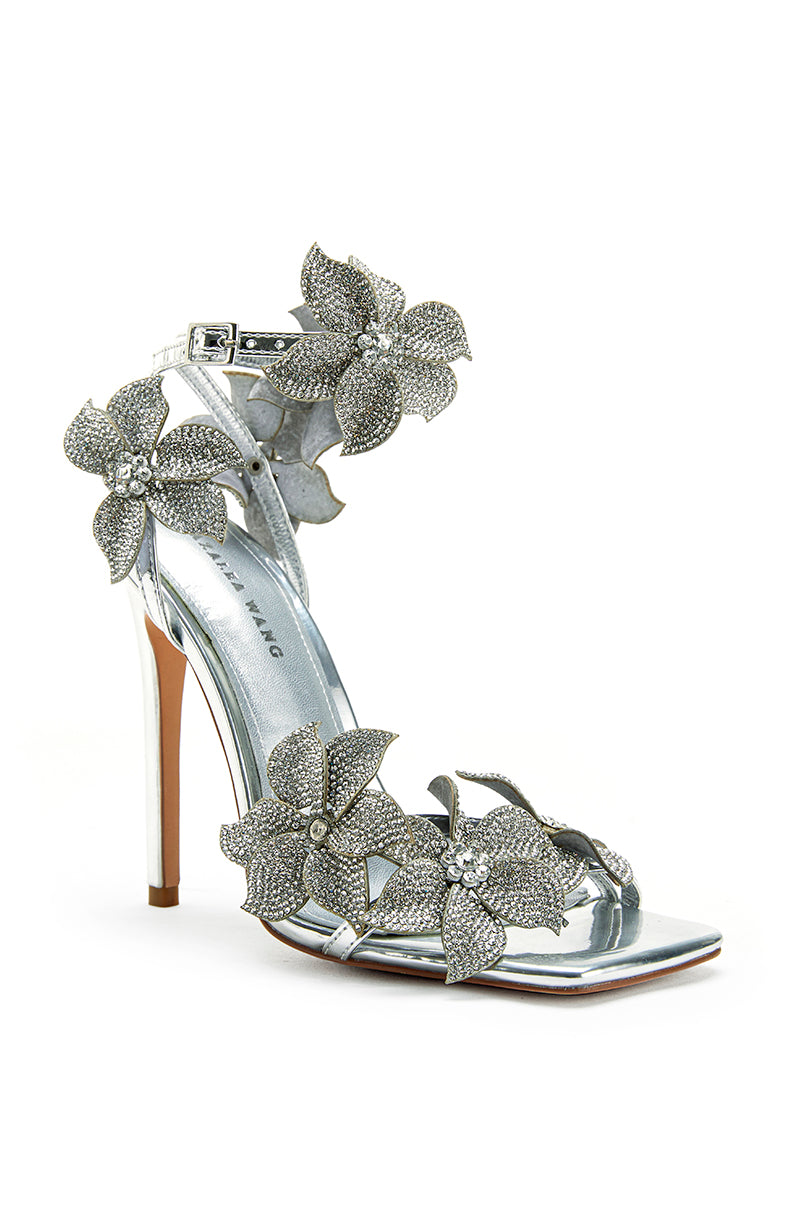 angled view of Metallic Silver stiletto open toe heels with decorative crystal embellished flowers