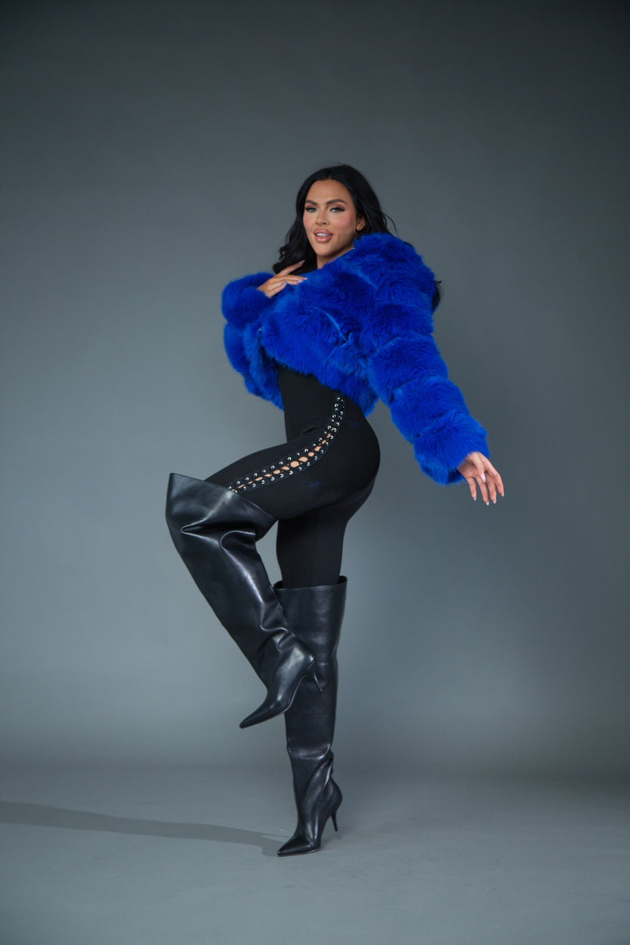 model posing while wearing flared pointed toe stiletto knee high boots