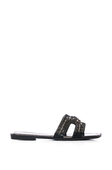 black flat slip on sandals with structured and embellished foot band