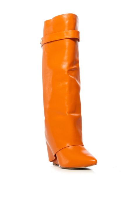 angled view of fashion forward orange faux leather wedge fold over boots with a pointed toe