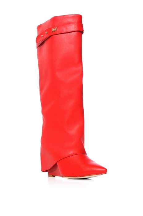 angled view of fashion forward red faux leather wedge fold over boots with a pointed toe