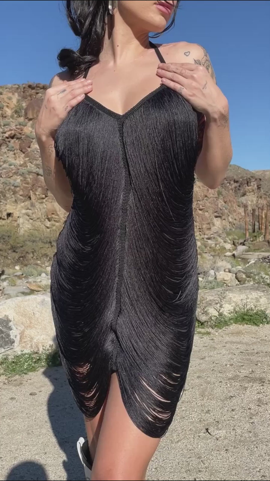 Video of black backless mini dress with all over string fringe