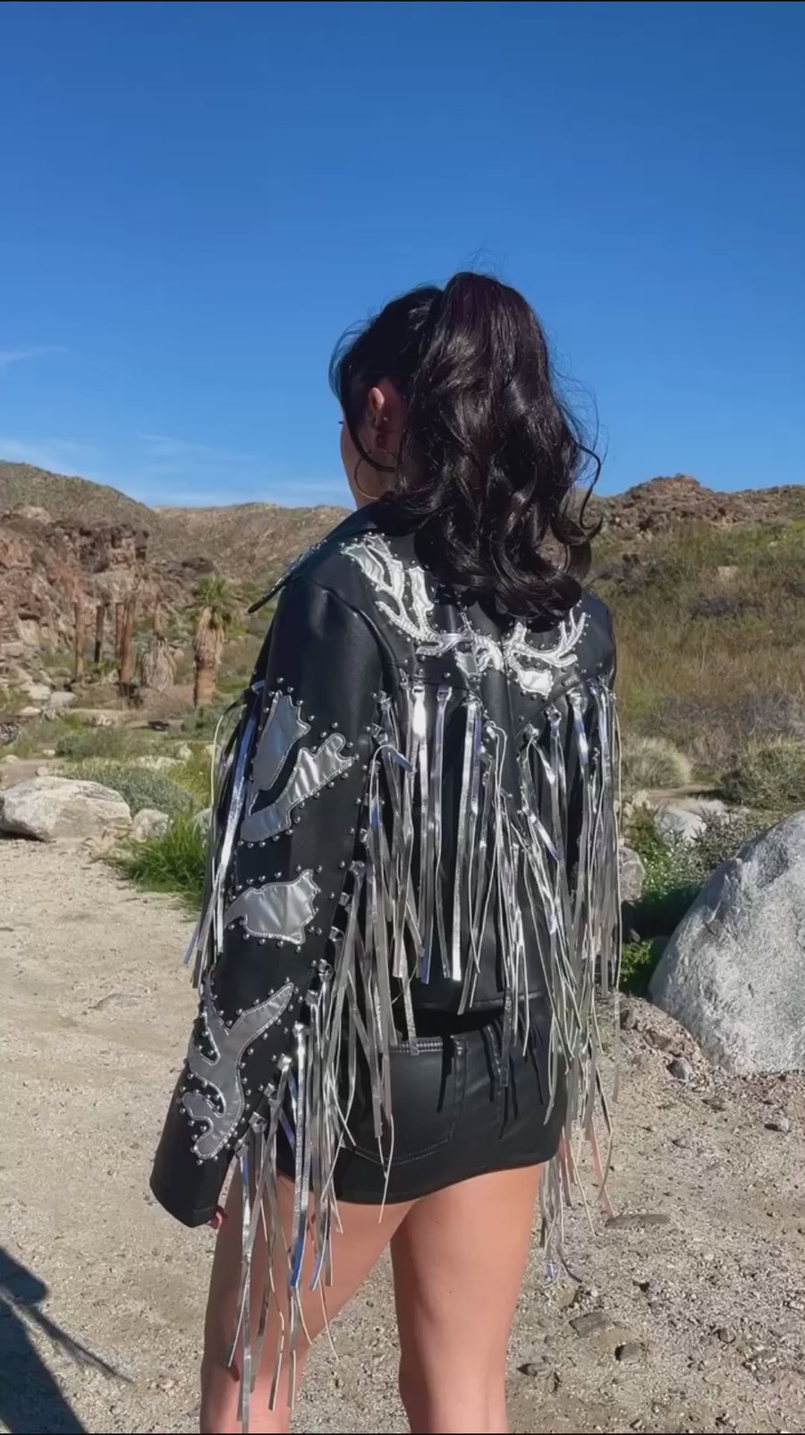 video of black faux leather western jacket with silver fringe and detail