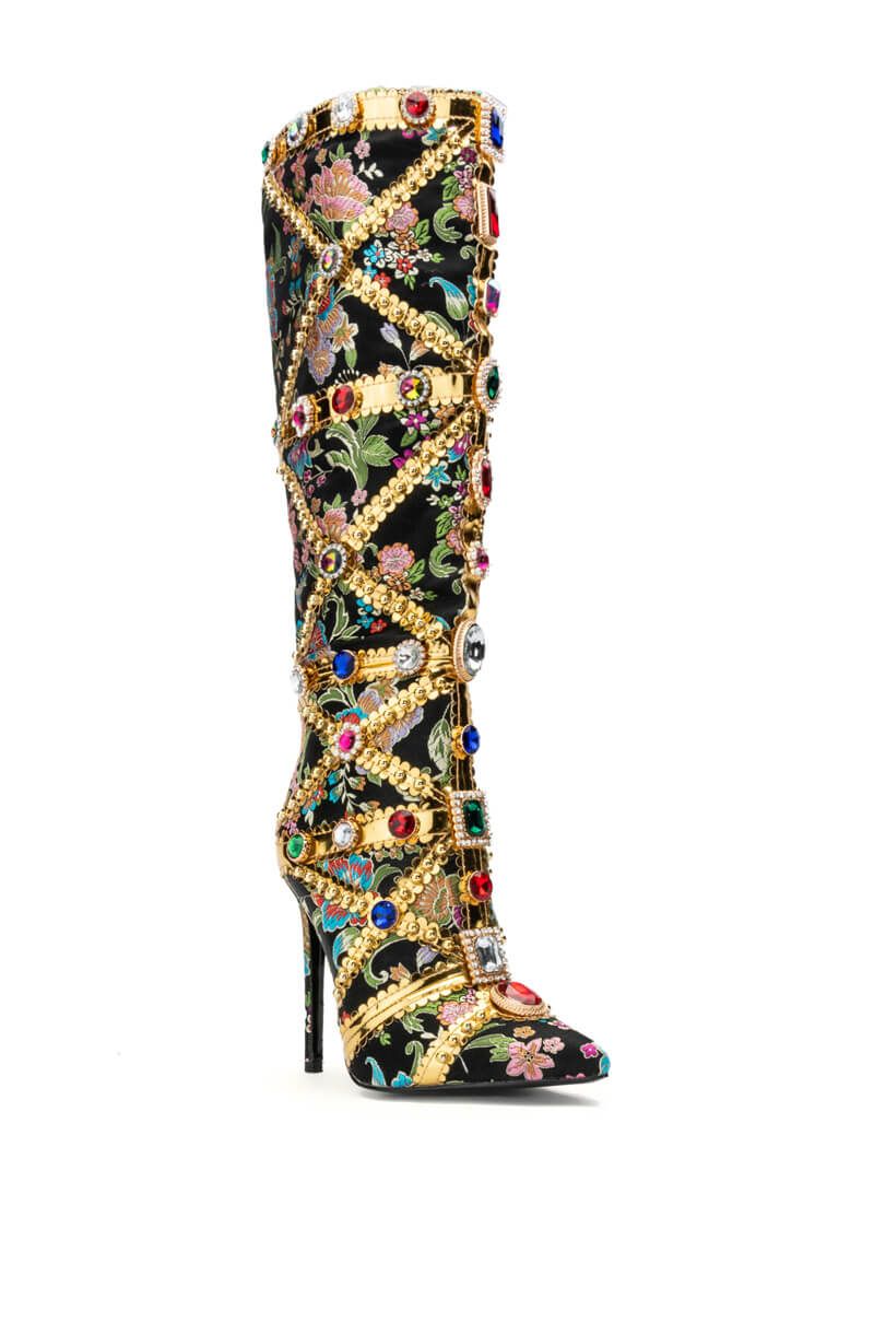 black heeled boots with a pointed toe, floral design, and gold details wrapped around the shoe with rhinestone bedazzle