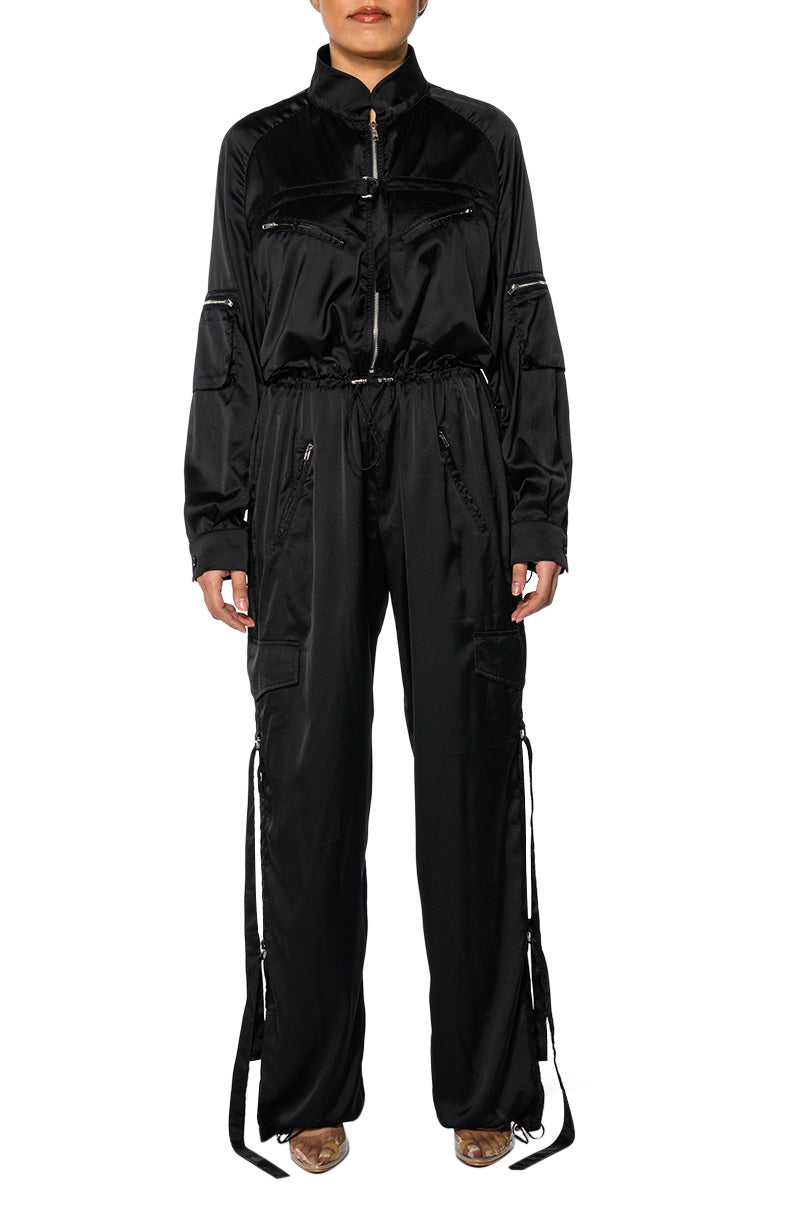black jumpsuit with zip-up style and athleisure tracksuit fit